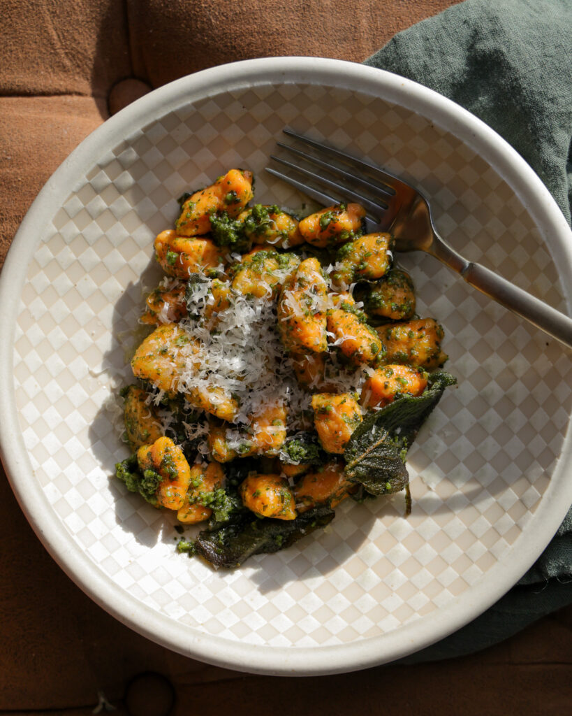 A bowl of homemade sweet potato gnocchi with crispy sage pesto