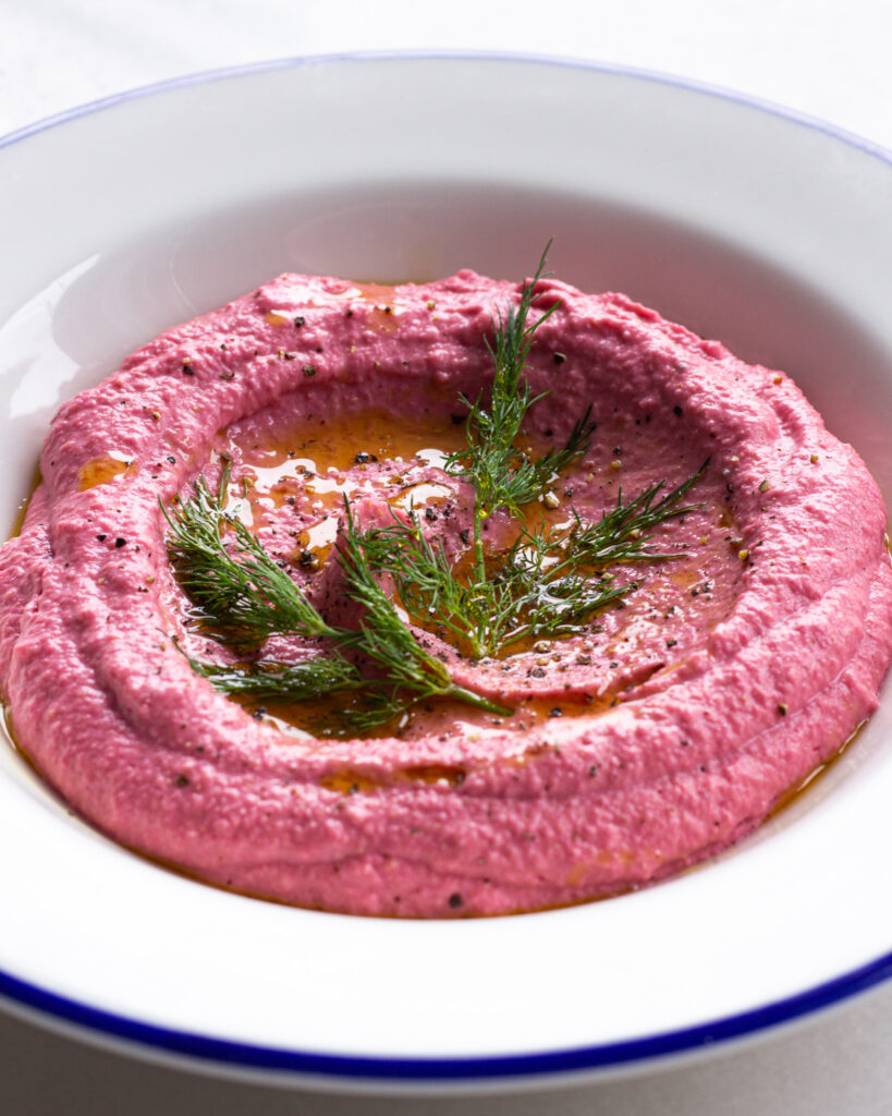 Beet hummus topped with lemon juice and dill. 