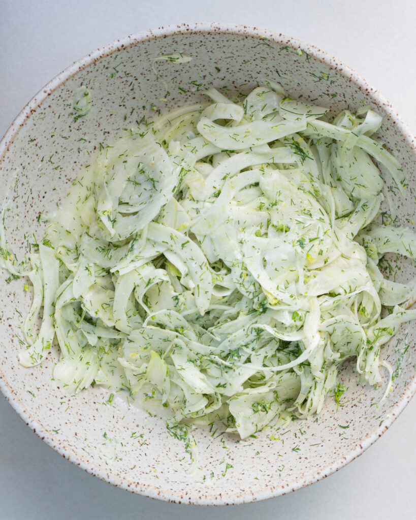 Fennel salad with dressing in bowl